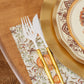 Sophistiplate Turkey & Gourds Guest Towels/20pk featuring a scalloped edge and fall pumpkin pattern, styled with a white and gold fork and knife next to a decorative plate.