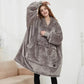 Person wearing a gray fleece Oversized Heatable Hoodie and pockets on a white background