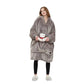 Person wearing a gray fleece Oversized Heatable Hoodie holding a small white bear plush toy on a white background