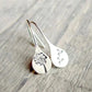 Close-up of women's sterling silver dandelion teardrop dangle earrings. Delicate unique design with real dandelion seeds.