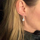 Chic women's sterling silver teardrop dangle earrings featuring a beautiful dandelion design. Elegant & unique gift for her.