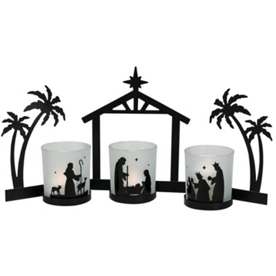 black metal nativity set featuring the Christmas star, palm trees on either side of the stable and attached candle holders with black metal silhouette nativity scenes around glass cup